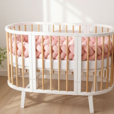 Tresse de lit bébé rose enveloppant tous les barreaux